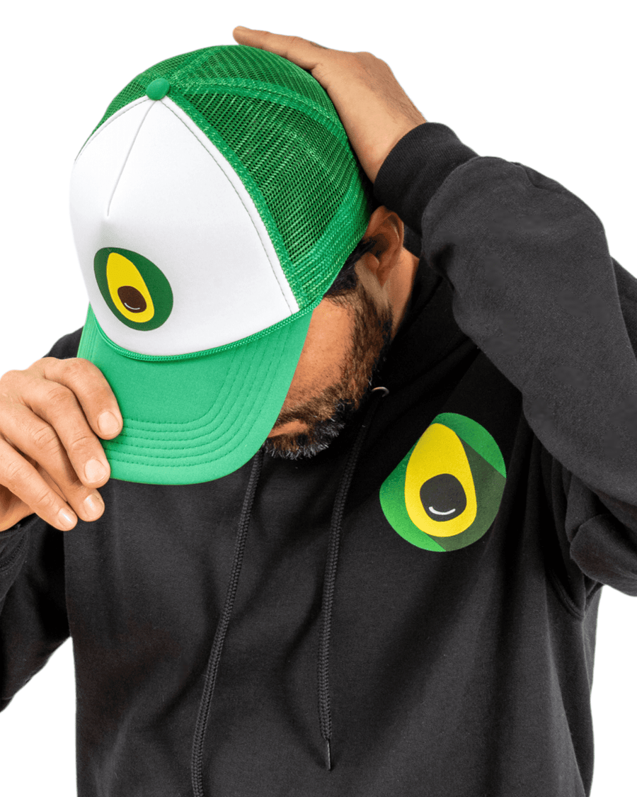 A man looking down while adjusting a Davocadoguy trucker cap on his head