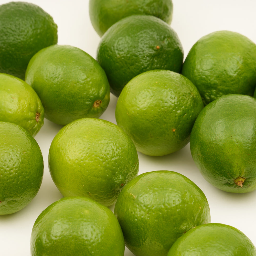 Fresh limes on a white background