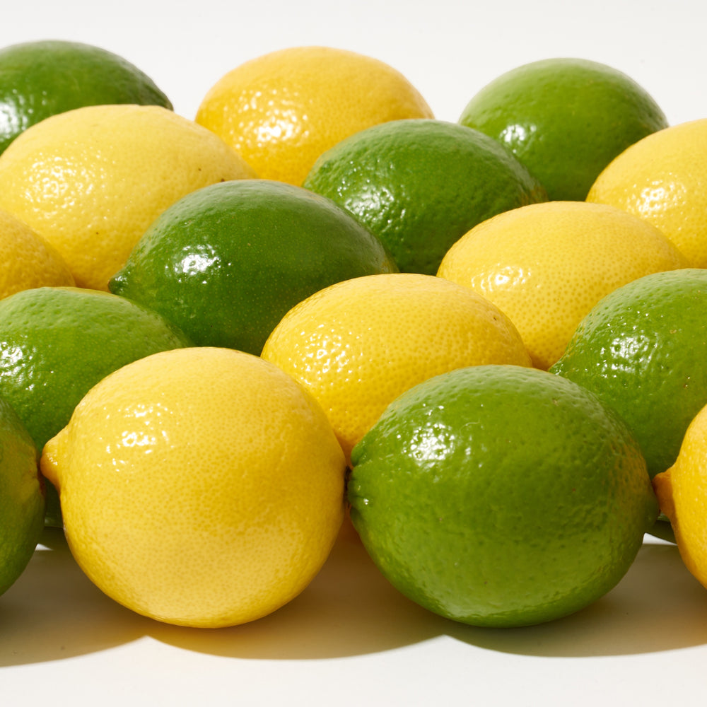 Fresh Limes and Lemons on a table.