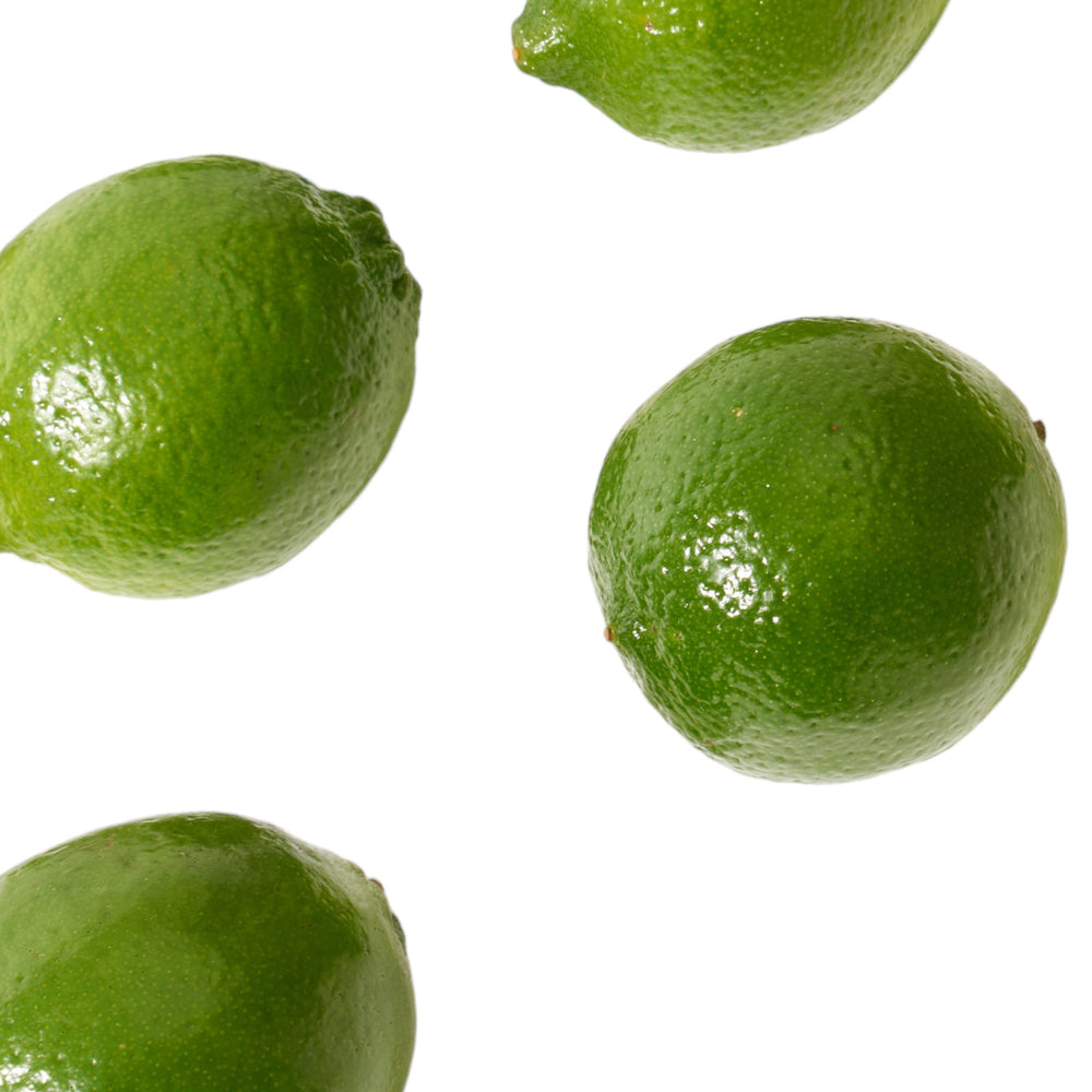 4 fresh limes, ready to eat, on a white background