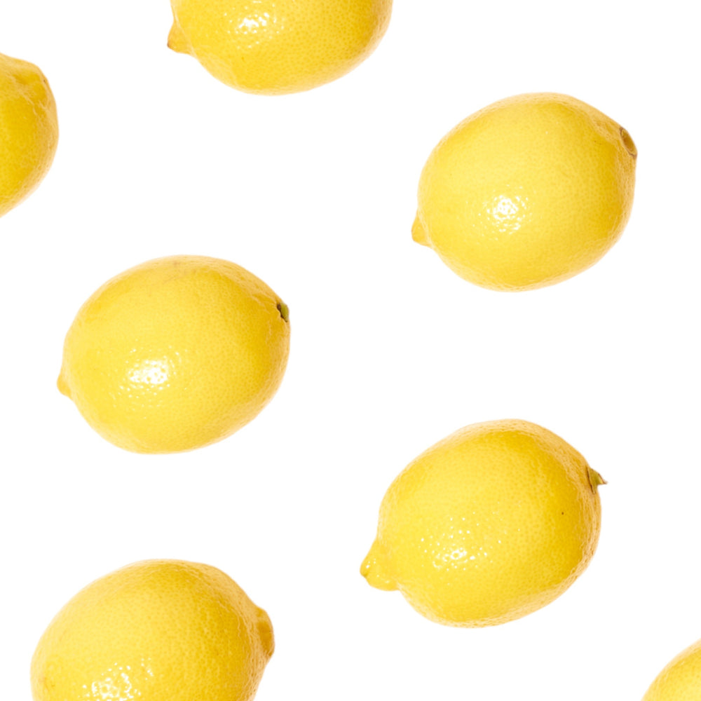 Fresh Lemons lined up on a white background