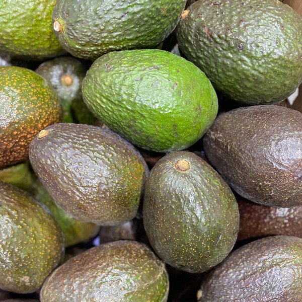 A stack of avocados from green to ripe