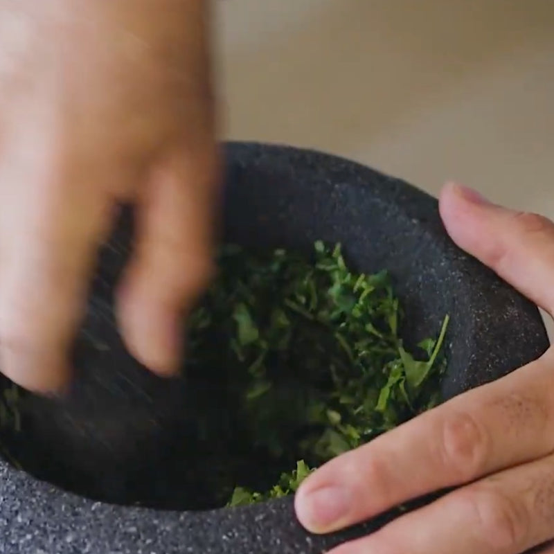 Grinding Cilantro, Salt and Peppers in a Molcajete