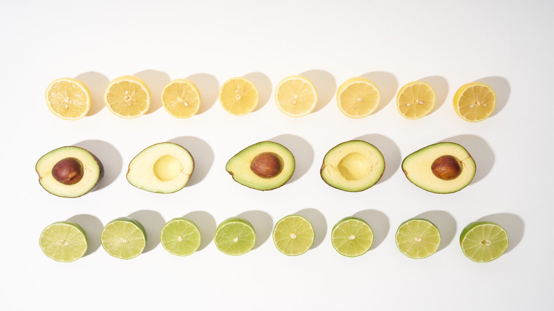 Davocadoguy Avocados, Lemons and Limes cut open and neatly lined up in 3 rows