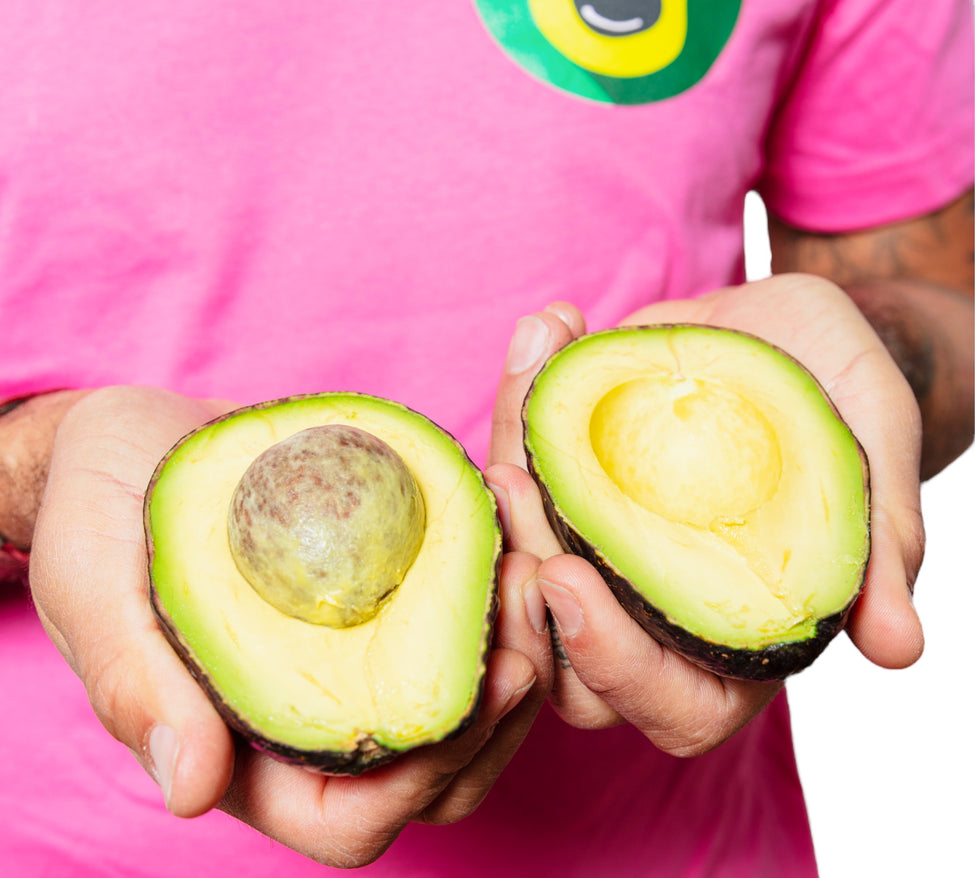 DavocadoGuy wears a Pink t-shirt and holds a ripe avocado cut open