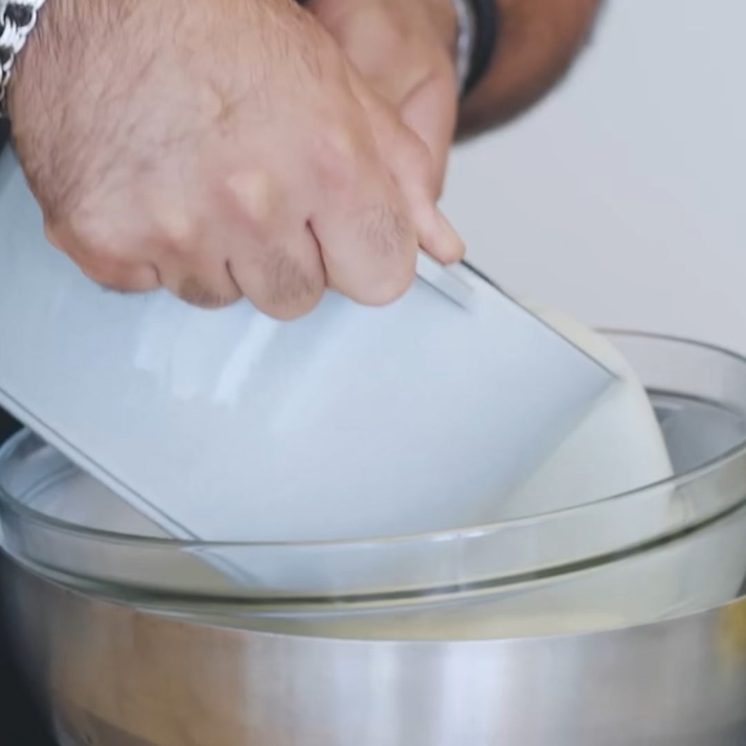 mixing ingredients in a bowl as part of the avocado ice cream preparation
