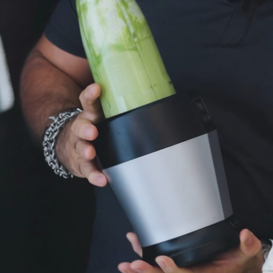 person mixing avocado in a mixer with a mesh strainer and ug nearby