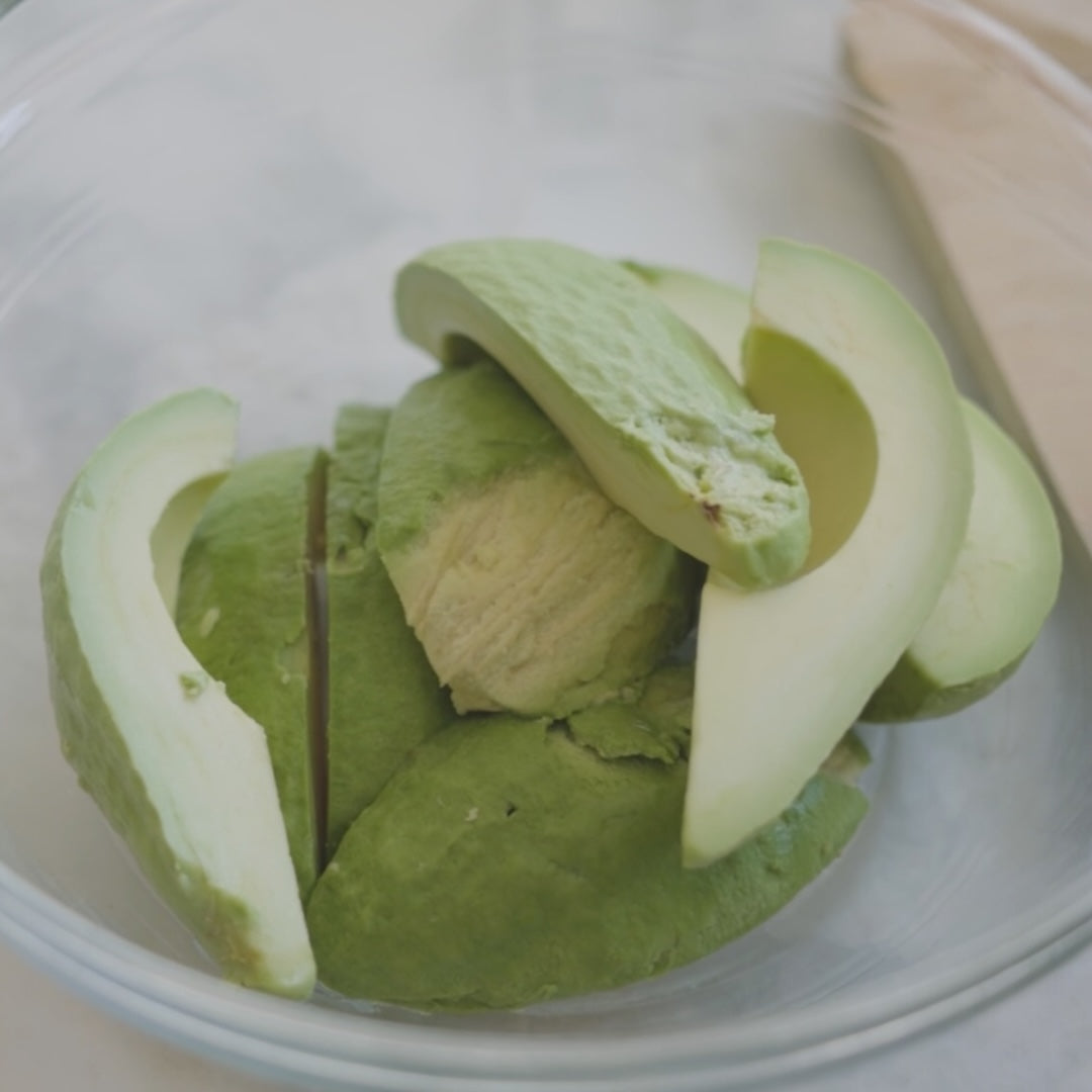 peeled avocado halves in a bowl