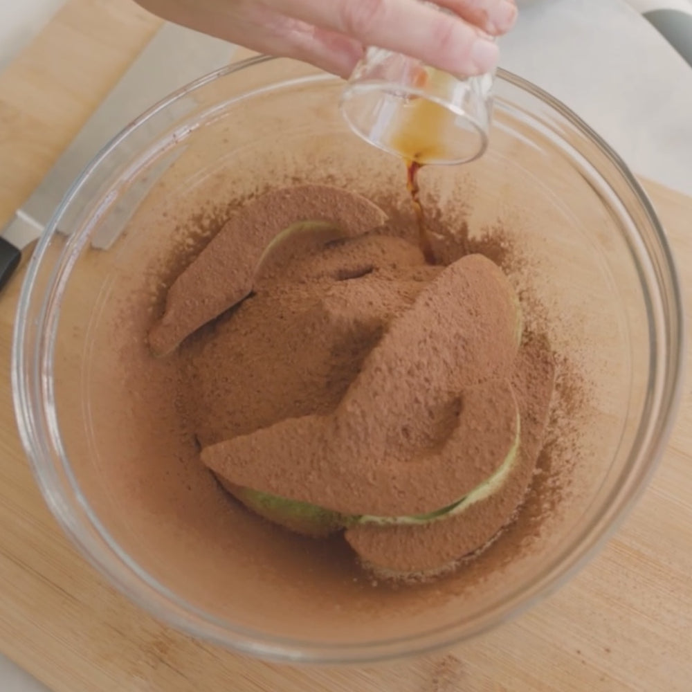 pourring liquid  into a bowl of cocoa powder and avocado