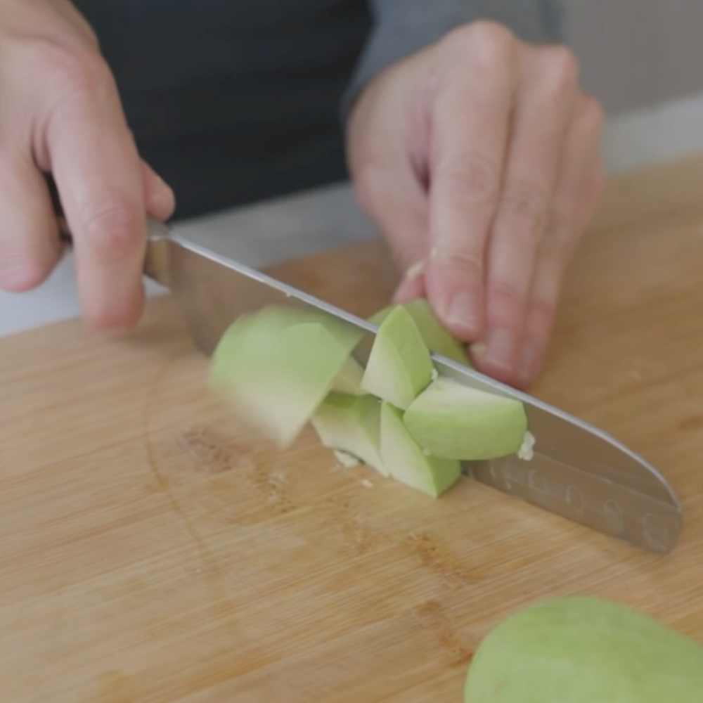chopping a avocado on a cutting board