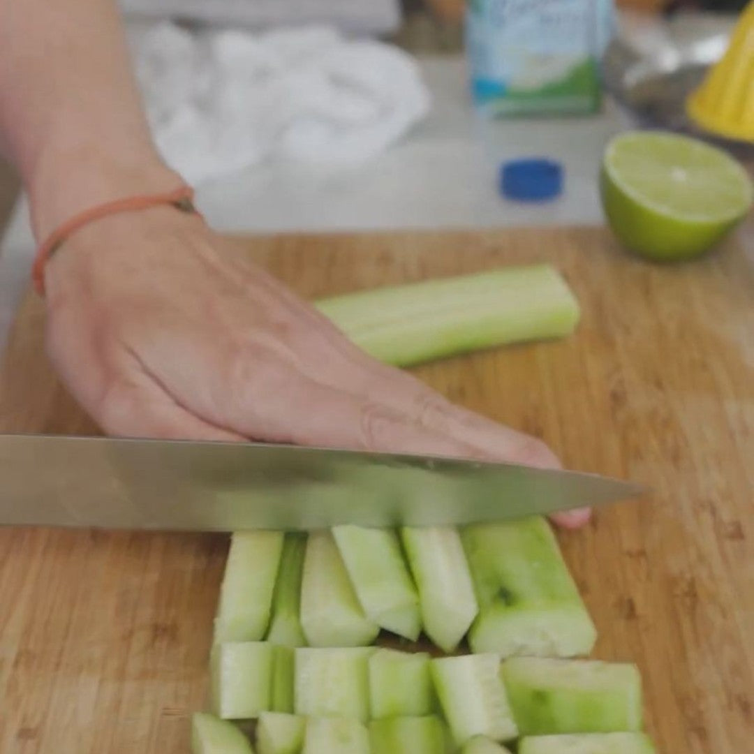 slicing cucumbers on a cutting board