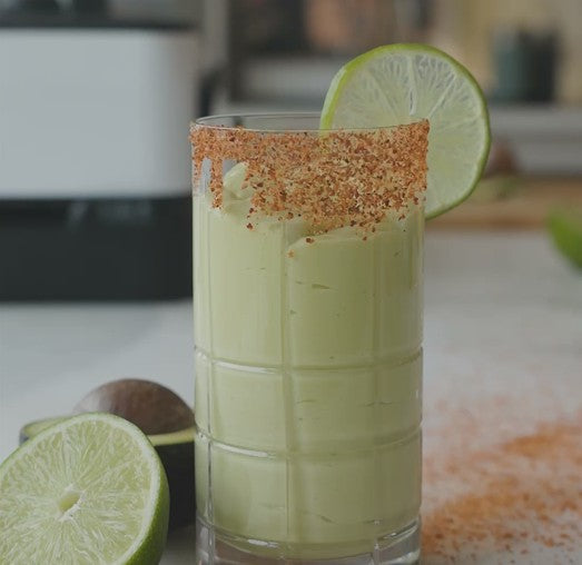 a creamy drink with a chili powder rim, garnished with a lime slice