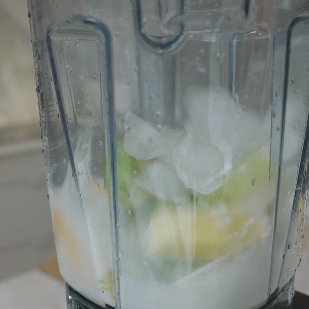ice and avocado and other ingredients in a blender